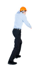 Back view of running engineer in helmet. Walking guy in motion. 