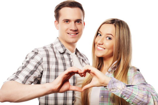 Happy couple  showing heart with their fingers
