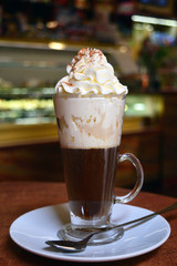 Viennese coffee in glass cup with whipped cream