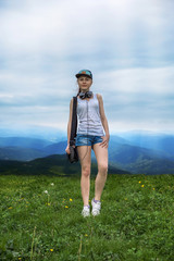 girl in mountains walk on a grass field