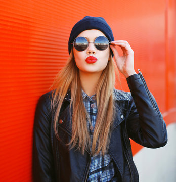 Portrait of fashionable blonde girl with red lipstick wearing a