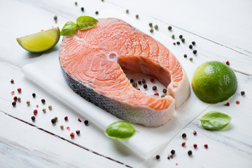 Norwegian salmon filet with spices over white wooden surface