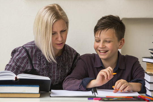 Young Student Engaged In The Lessons With His Teacher.