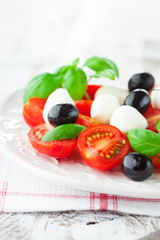 Tomatoes and mozzarella with basil leaves