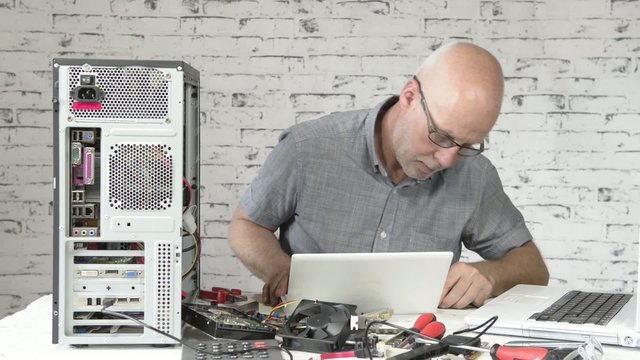 a technician repairing a computer 
