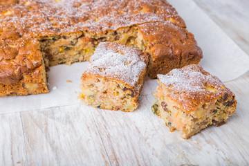 Homemade cake with dried fruits on white table