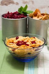 Glass bowl with cornflakes mixed with cranberries