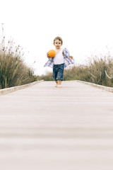 little boy playing on catwalk in holidays at outdoors