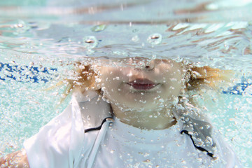 Child Swimming in Pool Underwater
