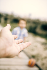 Father offering hand to his son at outdoors