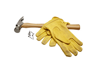 Hammer, nails and work gloves isolated on white