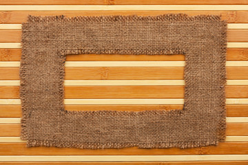 Frame made of burlap lying on a bamboo  mat