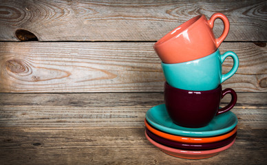 set of colorful cups and dishes and dessert