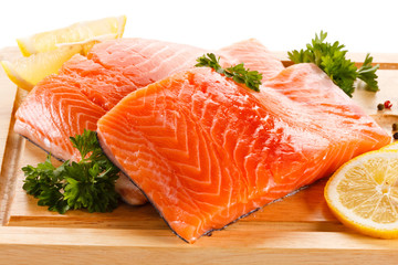 Fresh raw salmon steaks on cutting board 
