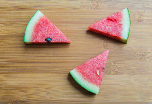 Piece of Water melon on wooden chopping block