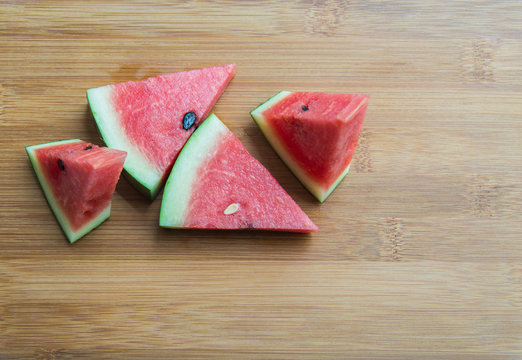 Piece of Water melon on wooden chopping block