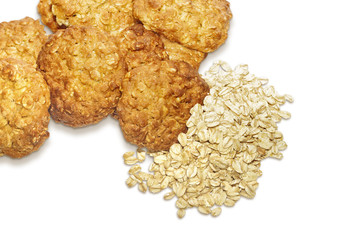 Oatmeal cookies and oat-flakes isolated on white background