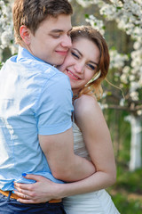 Fototapeta premium bride and groom in spring park hugging