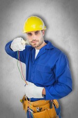 Composite image of confident repairman holding cables