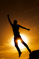 Fototapeta na wymiar Silhouettes of jumping man
