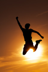 Obraz na płótnie Canvas Silhouettes of jumping man