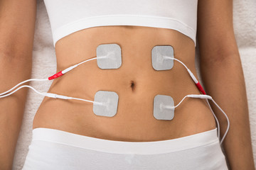 Woman With Electrodes On Her Stomach - obrazy, fototapety, plakaty