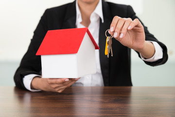 Businesswoman Holding House Model And Keys
