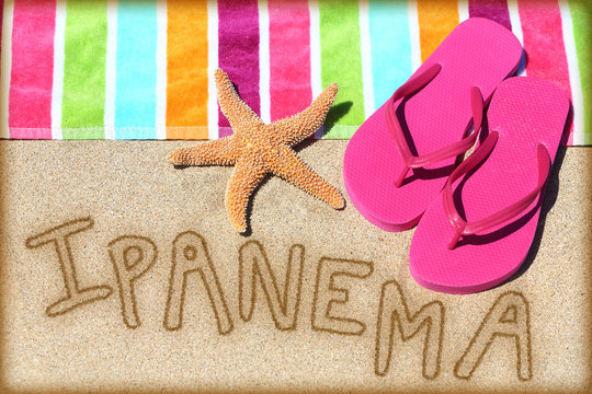 Ipanema beach vacation concept - sand and towel