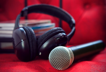 microphone and head phone on red sofa leather use for entertainm