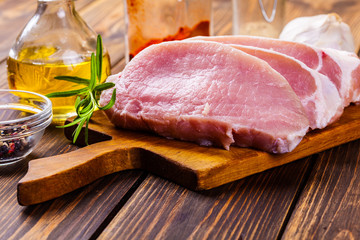 Raw pork slices on a chopping board