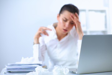 Portrait of tired young business woman with laptop computer