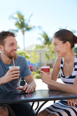 Cafe couple having fun drinking coffee talking