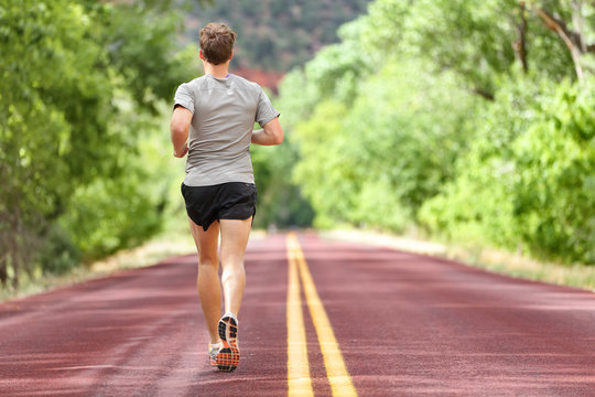 Male runner running on road training for fitness