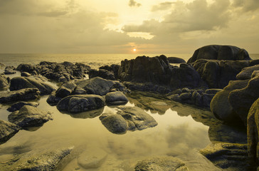 Beautiful sunset and rocks on beach in Phang Nga Province.