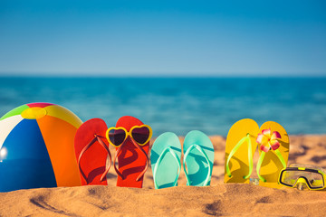 Fototapeta na wymiar Flip-flops, beach ball and snorkel on the sand