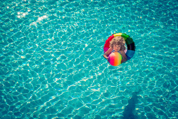 Happy child playing in swimming pool