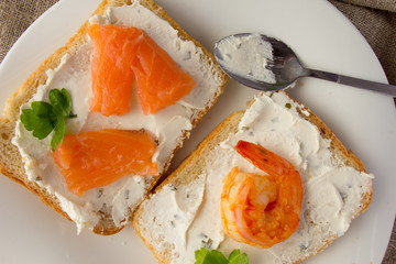 Wheat bread toasts with cream cheese, smoked salmon and shrimp