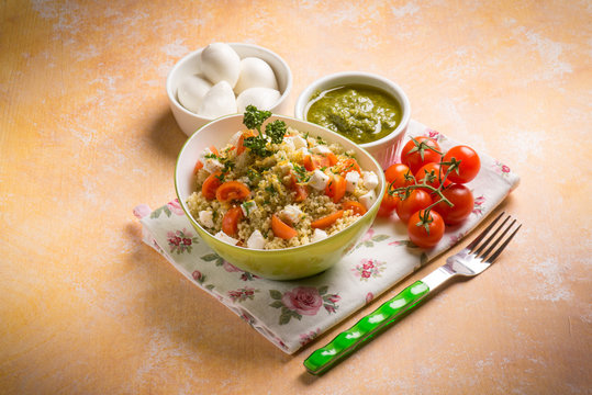 vegetarian couscous with mozzarella tomatoes and pesto sauce