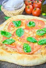 Rustic italian pizza with mozzarella, cheese and basil leaves