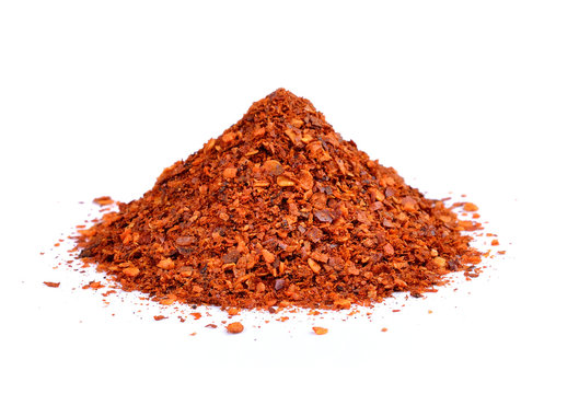Powdered dried red pepper on white background