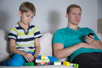 Sad little boy playing alone