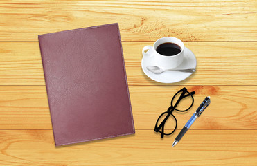 Notebook with office supplies with pen with glasses and cup of c