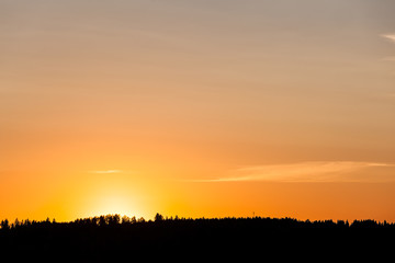 Sunset behind lake and forest