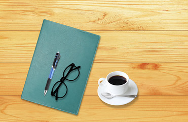 Notebook with office supplies with pen with glasses and cup of c