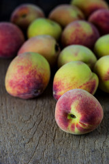 group of fresh peaches on wood background