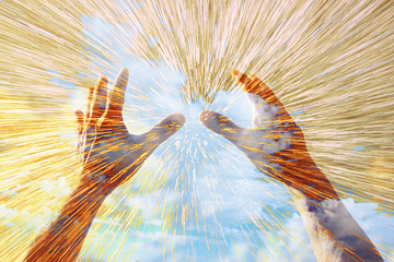hands raised in prayer against sky. double exposure effect