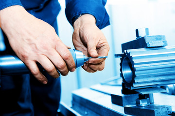 Man working on drilling and boring machine. Industry