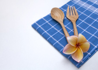 Wooden fork and spoon on blue napkin 