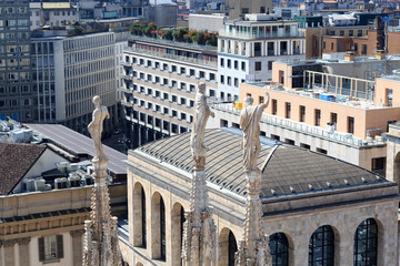 Fototapeta premium Cathedral statue and view of Milan cityscape