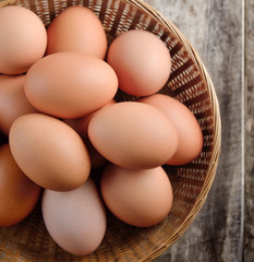 Easter egg in a basket on wodden table